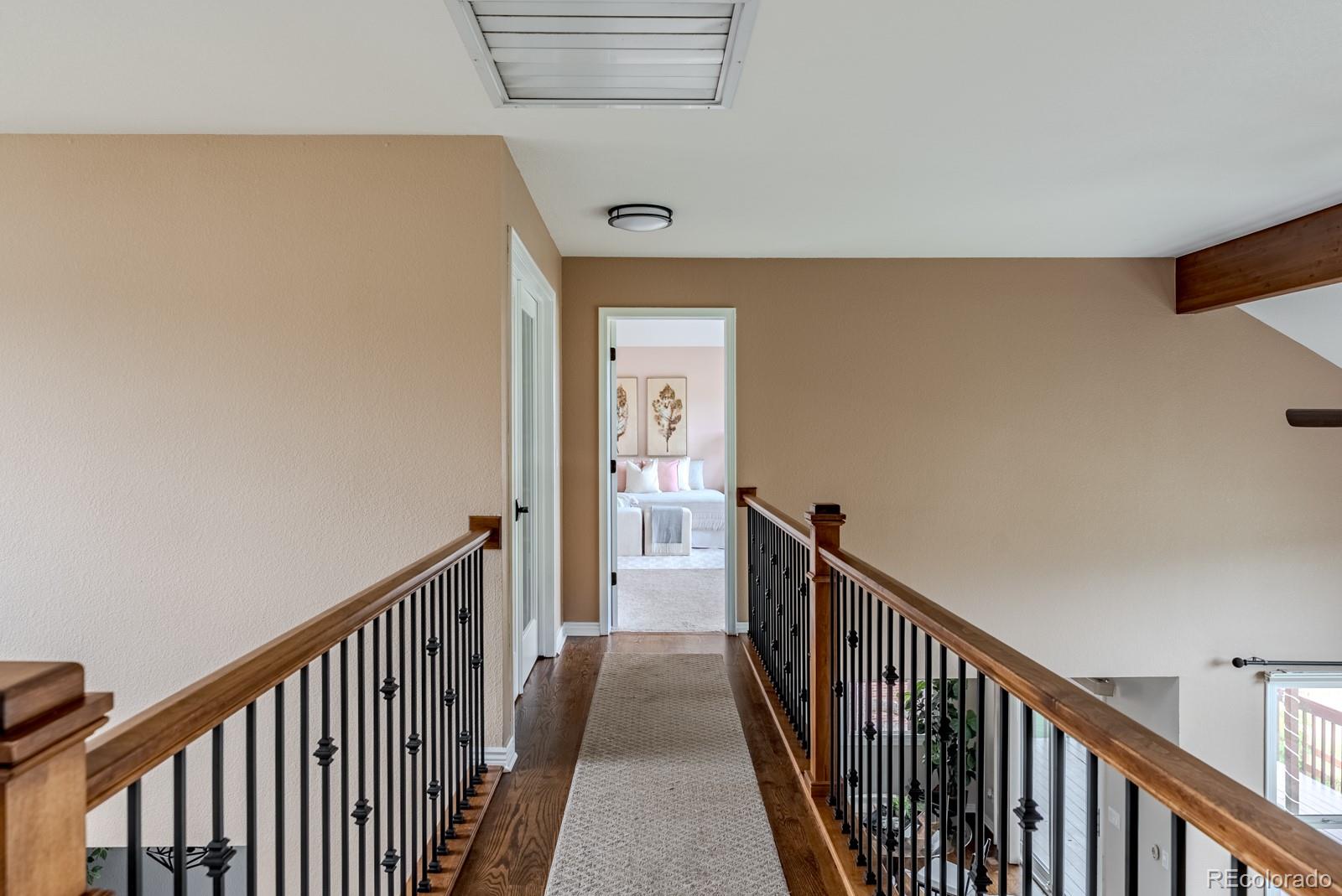 1914 Terrace Drive Highlands Ranch, CO 80126 - Photo 29 of 47 a view of a hallway with wooden floor and stairs