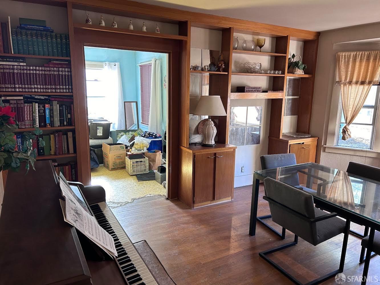 Rawson Street Oakland, CA 94619 - Photo 6 of 10 a living room with furniture a bookshelf and a window