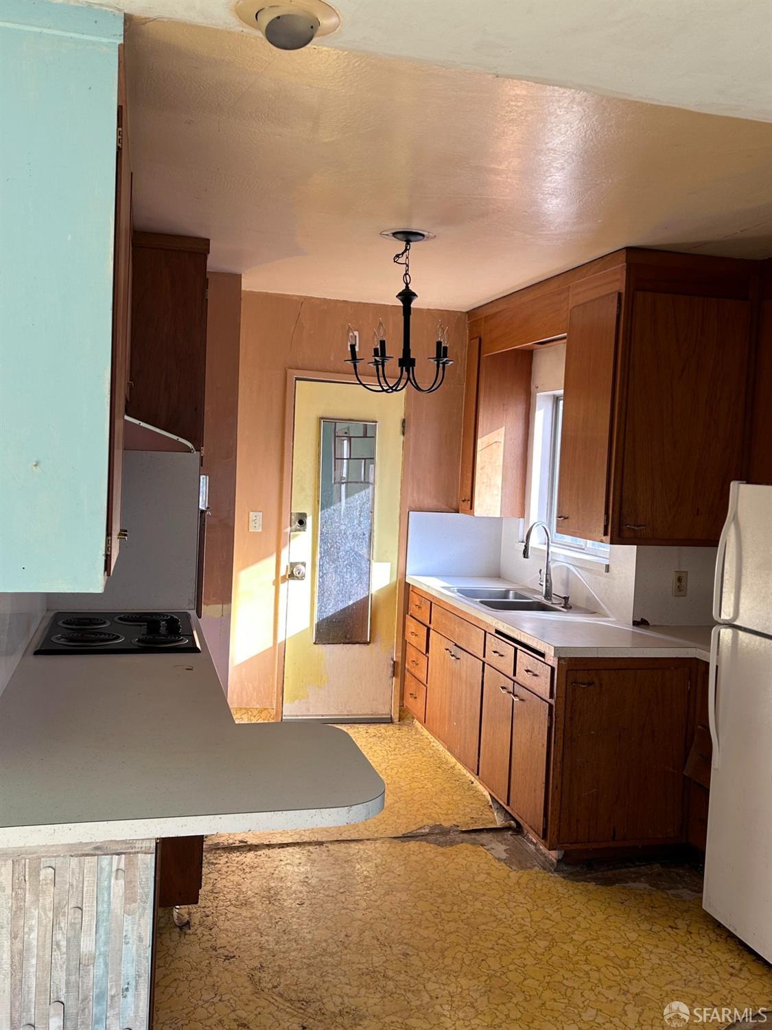 Rawson Street Oakland, CA 94619 - Photo 7 of 10 a kitchen with stainless steel appliances granite countertop a sink and a refrigerator
