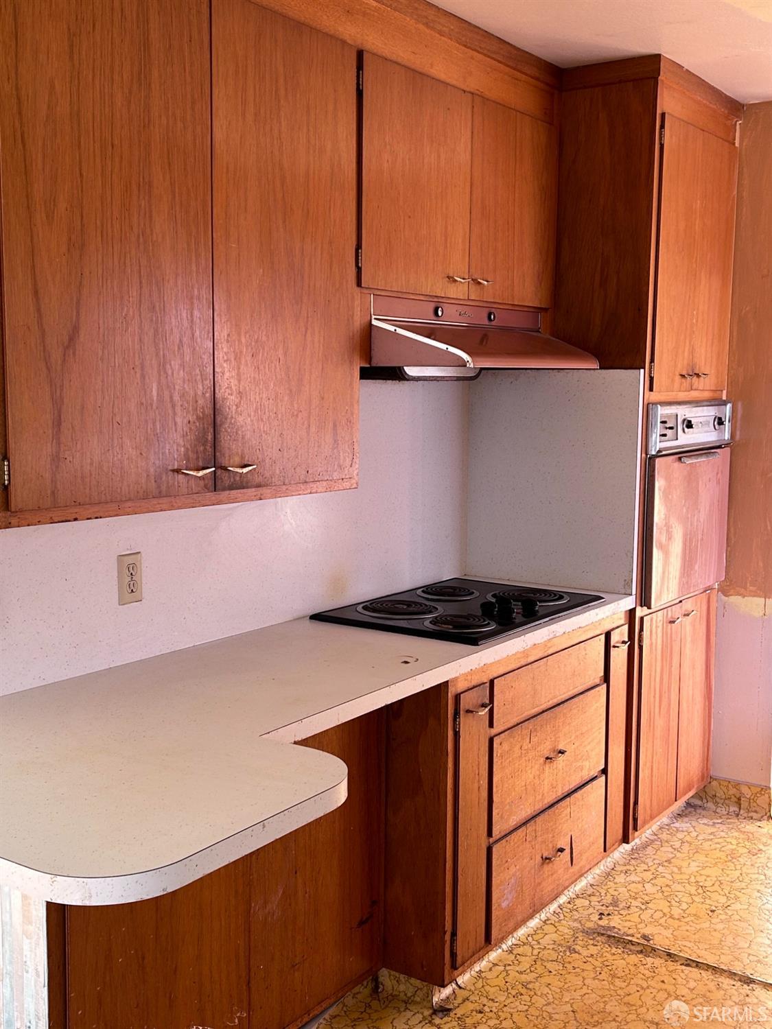 Rawson Street Oakland, CA 94619 - Photo 8 of 10 a kitchen with stainless steel appliances a stove a microwave and a refrigerator
