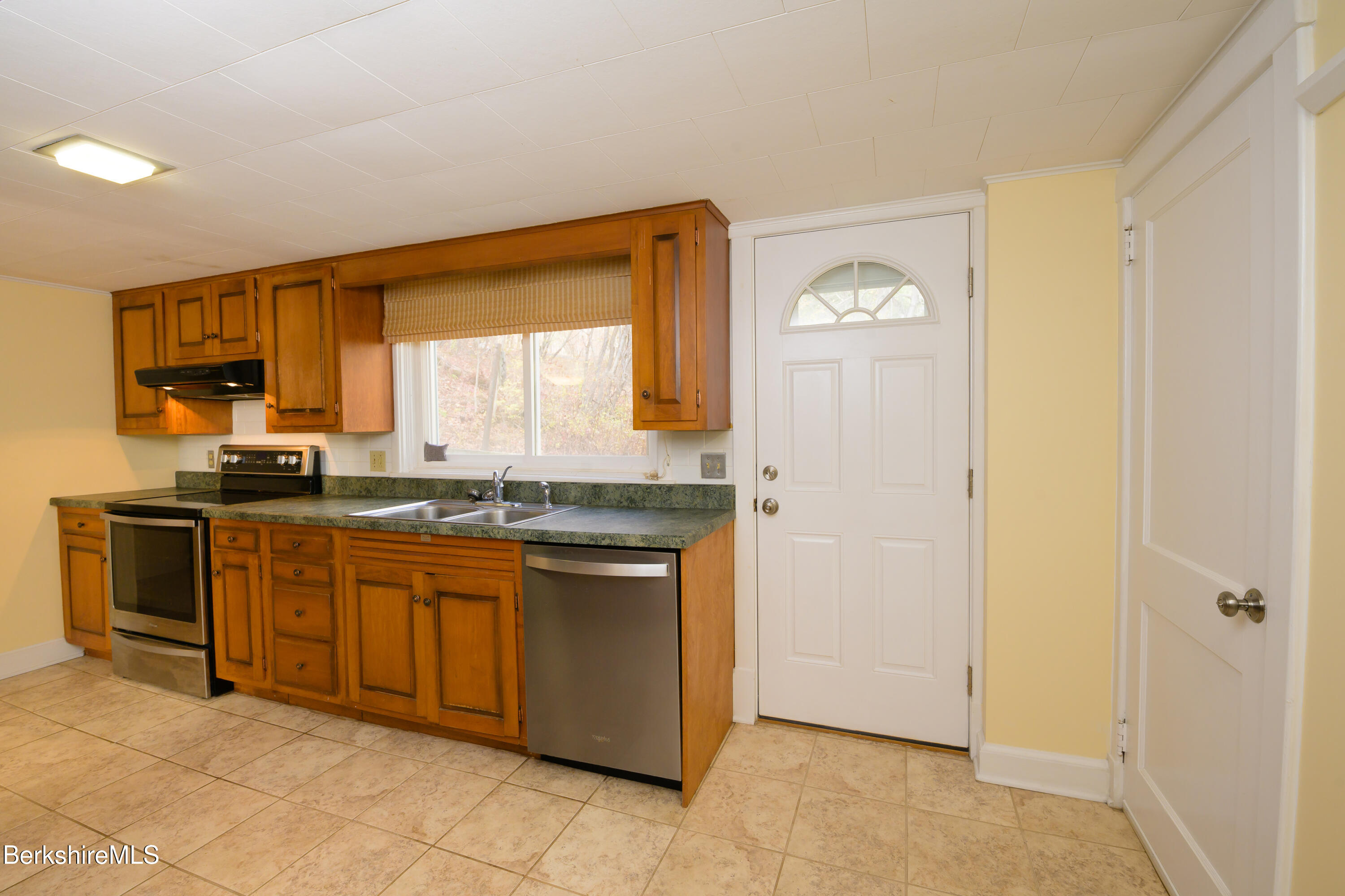 363 Henderson Road Williamstown, MA 01267 - Photo 11 of 24 a kitchen with stainless steel appliances granite countertop a stove a sink and a refrigerator with wooden cabinets
