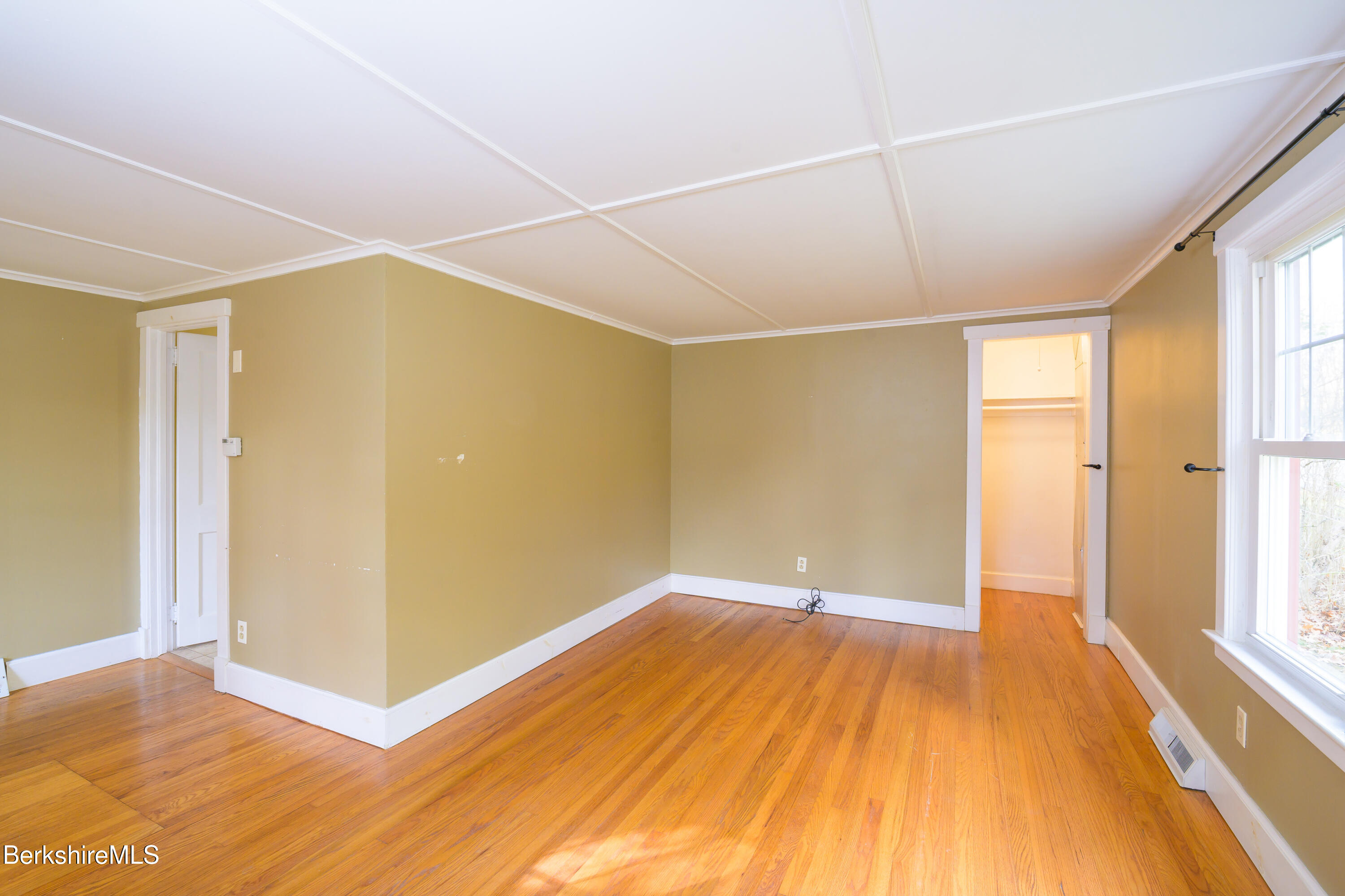 363 Henderson Road Williamstown, MA 01267 - Photo 14 of 24 a view of an empty room with wooden floor and a window