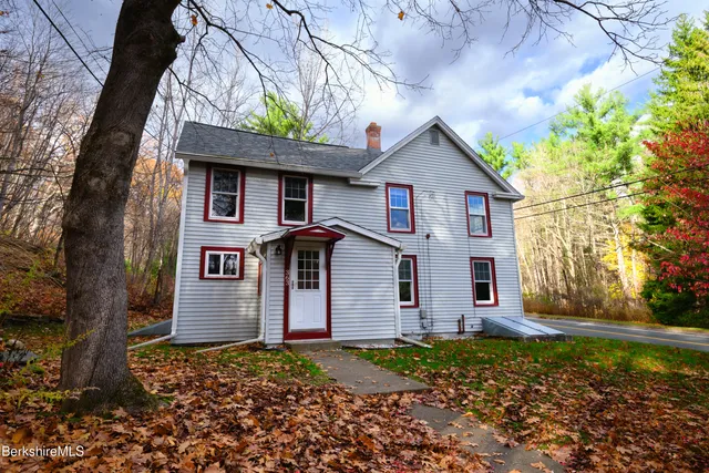 a front view of house with a garden