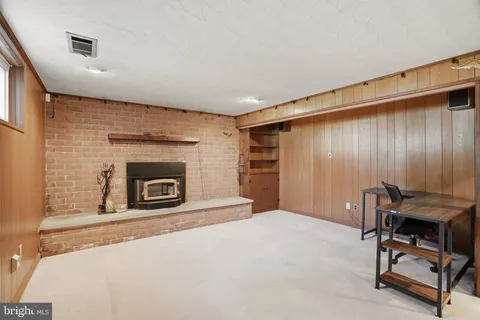 a livingroom with a fireplace and a window