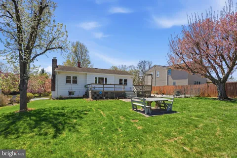 a view of a house with a yard porch and sitting area