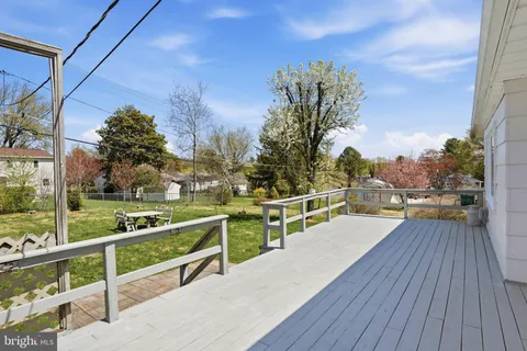 a view of a balcony with wooden floor and yard