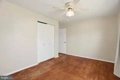 a view of an empty room with a fan