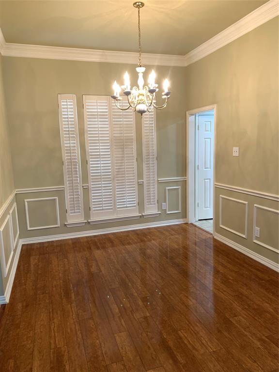 4914 Shadowood Road Colleyville, TX 76034 - Photo 2 of 28 Formal Diningroom featuring a chandelier, a decorative wall, ornamental molding, hardwood / wood-style floors, and a wainscoted wall