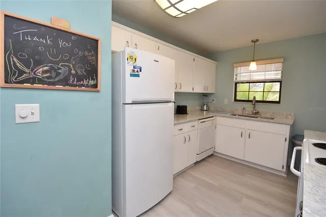 a kitchen with a refrigerator and a sink