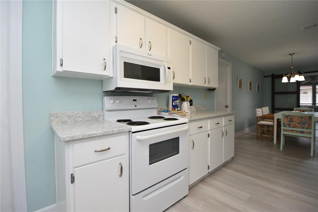 59 Fallen Oak Lane Palm Coast, FL 32137 - Photo 14 of 35 a kitchen with stainless steel appliances granite countertop a stove a sink and a microwave