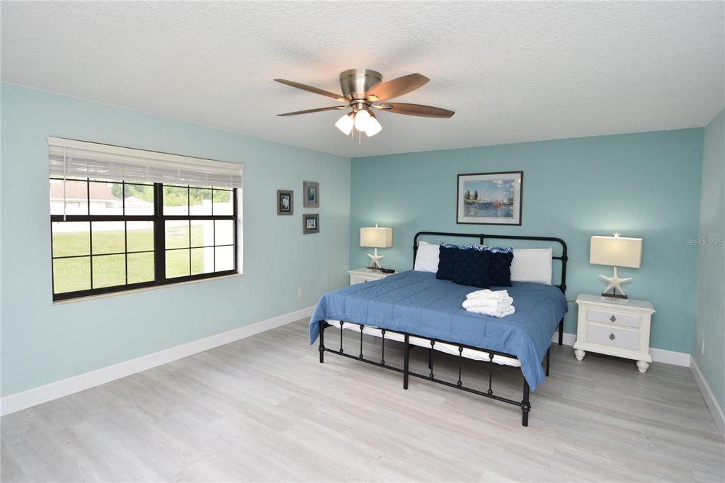 59 Fallen Oak Lane Palm Coast, FL 32137 - Photo 17 of 35 a bedroom with a bed and a table