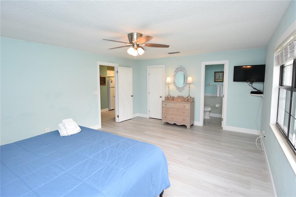 59 Fallen Oak Lane Palm Coast, FL 32137 - Photo 18 of 35 a bedroom with a bed and a chandelier