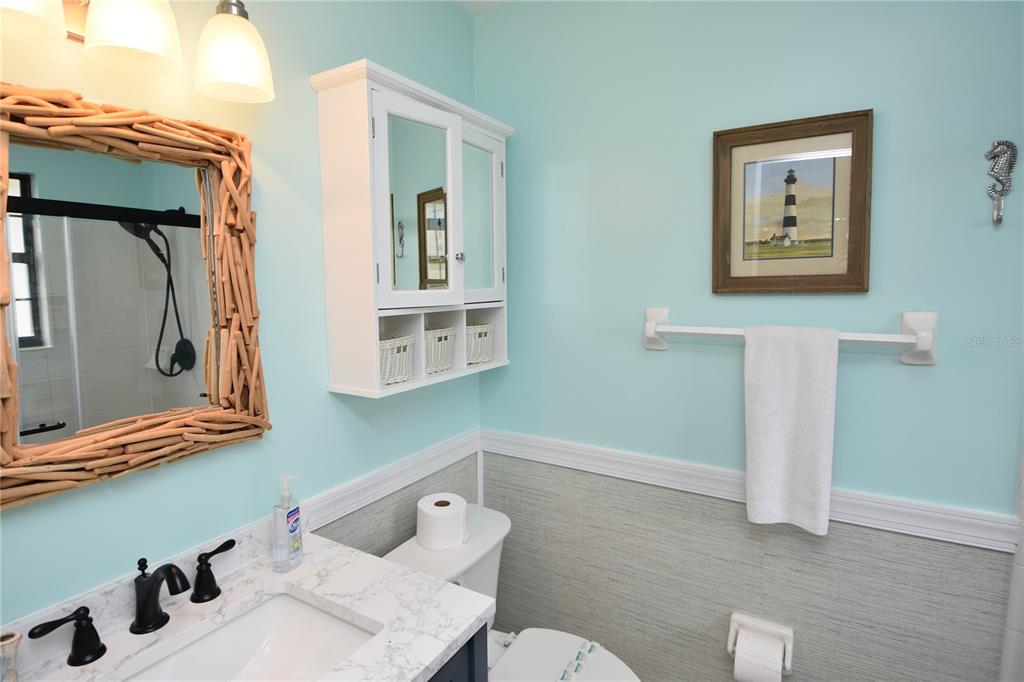 59 Fallen Oak Lane Palm Coast, FL 32137 - Photo 21 of 35 a bathroom with a toilet sink and mirror