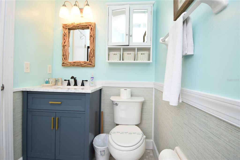 59 Fallen Oak Lane Palm Coast, FL 32137 - Photo 23 of 35 a bathroom with a toilet sink vanity and mirror