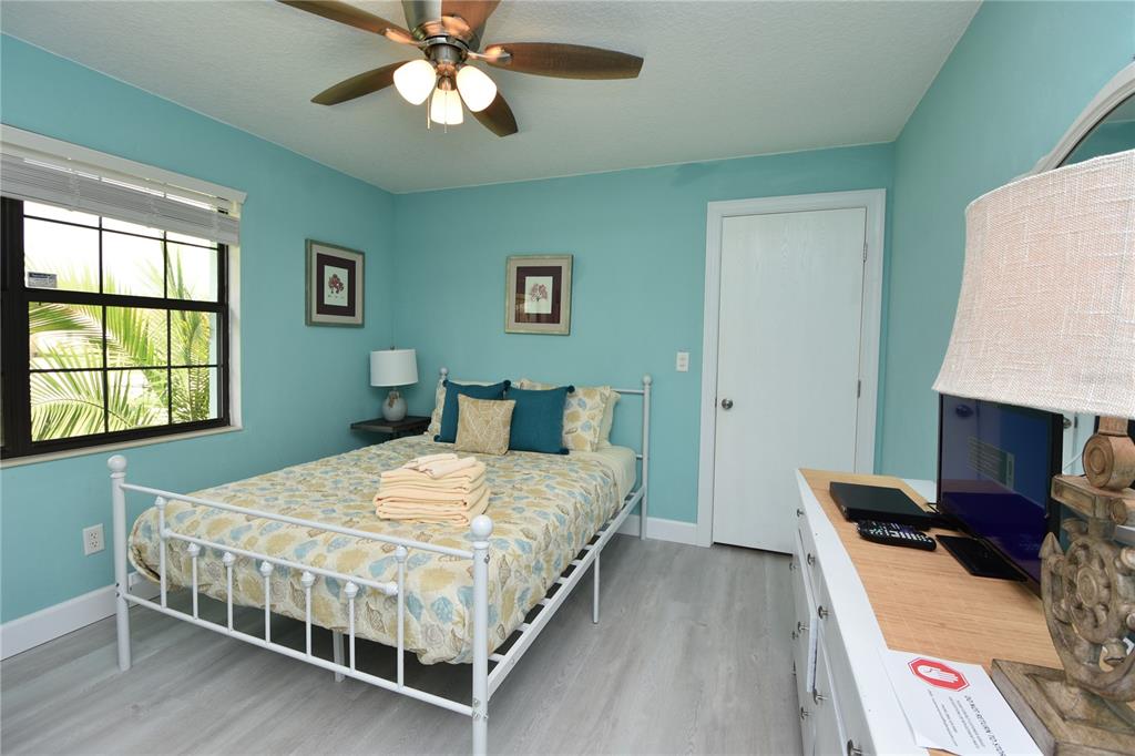 59 Fallen Oak Lane Palm Coast, FL 32137 - Photo 26 of 35 a bedroom with a bed and a flat screen tv