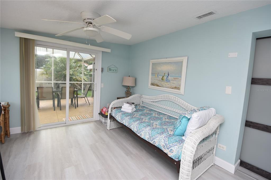 59 Fallen Oak Lane Palm Coast, FL 32137 - Photo 30 of 35 a bedroom with a bed and wooden floor