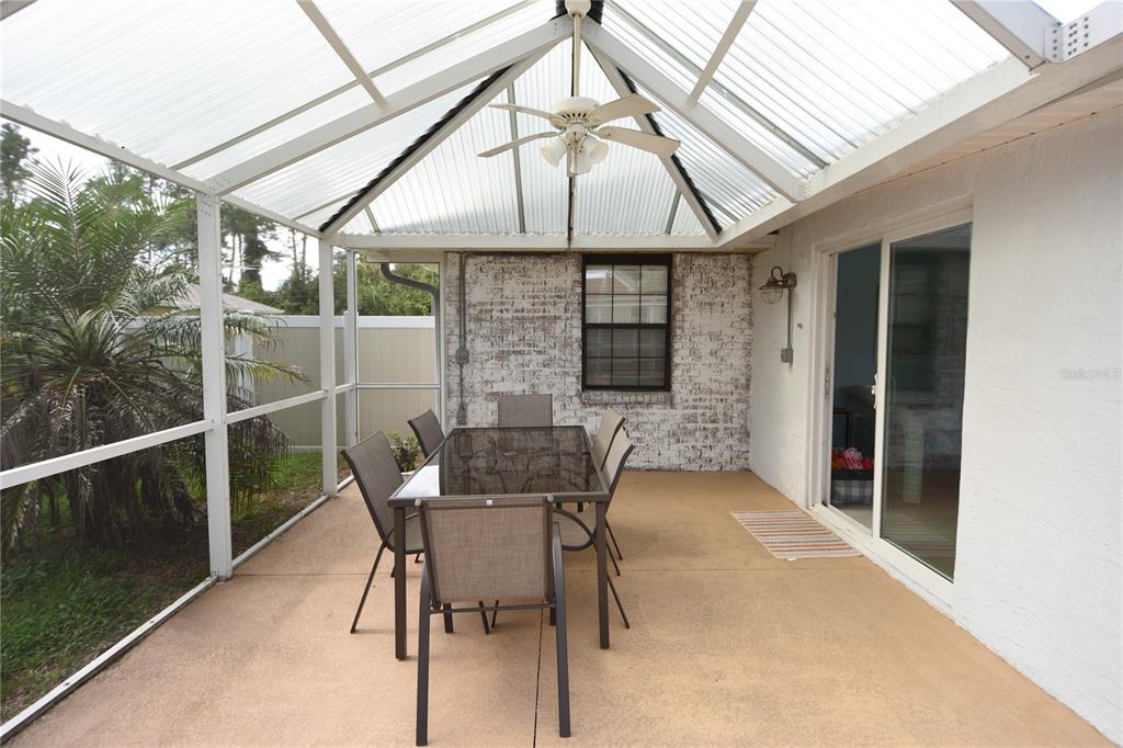 59 Fallen Oak Lane Palm Coast, FL 32137 - Photo 34 of 35 a patio with table and chairs and potted plants