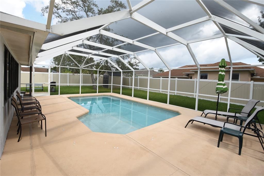 59 Fallen Oak Lane Palm Coast, FL 32137 - Photo 35 of 35 a view of a swimming pool with a lounge chair