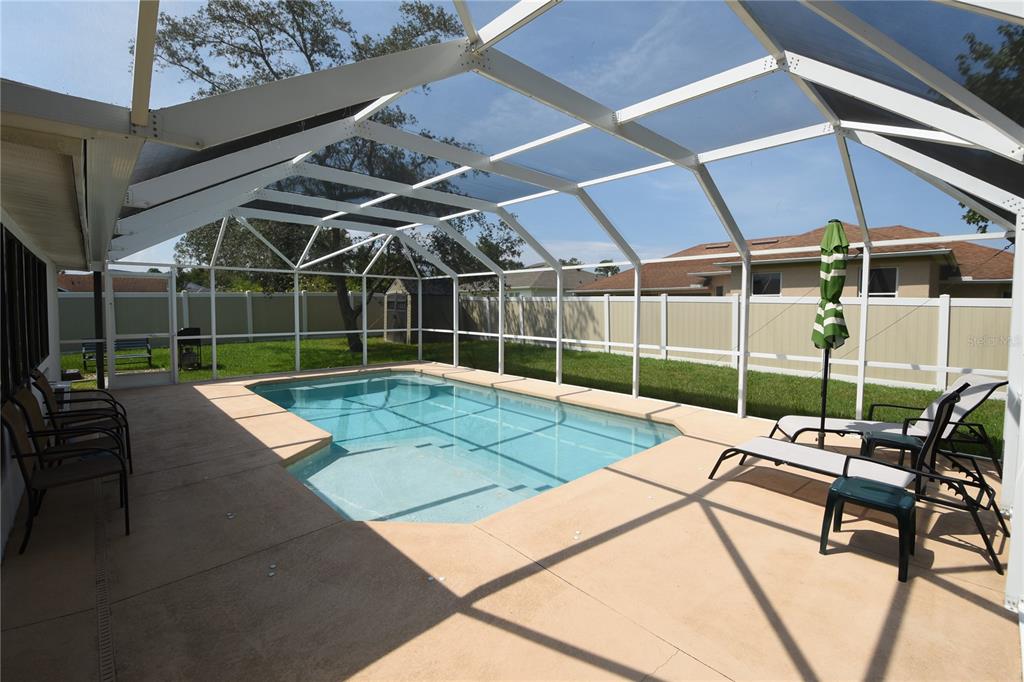 59 Fallen Oak Lane Palm Coast, FL 32137 - Photo 4 of 35 a view of a backyard with chairs and a small cabin