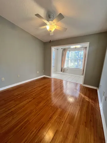 a large kitchen with cabinets and wooden floor