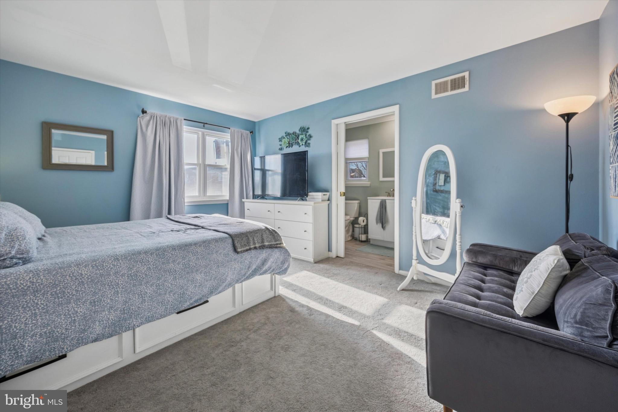 7011 Matthias Street Philadelphia, PA 19128 - Photo 11 of 28 a spacious bedroom with a bed couch and window