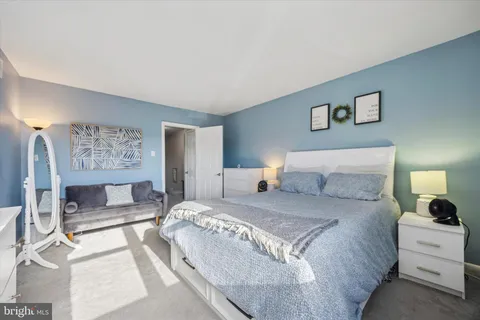 a bedroom with a large bed and a couch