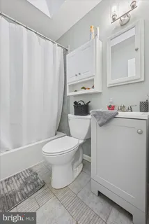 a white toilet sitting next to a bathroom sink