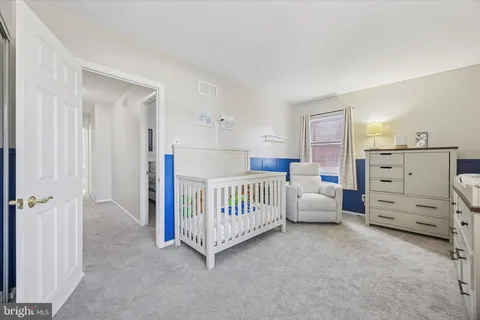 a view of a bedroom with baby bed