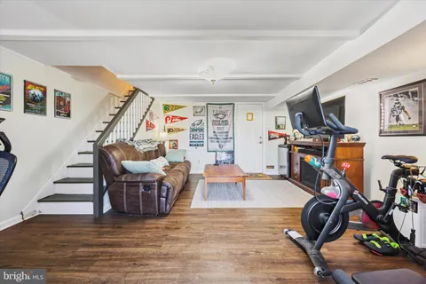 a view of a livingroom with furniture and a gym cycle