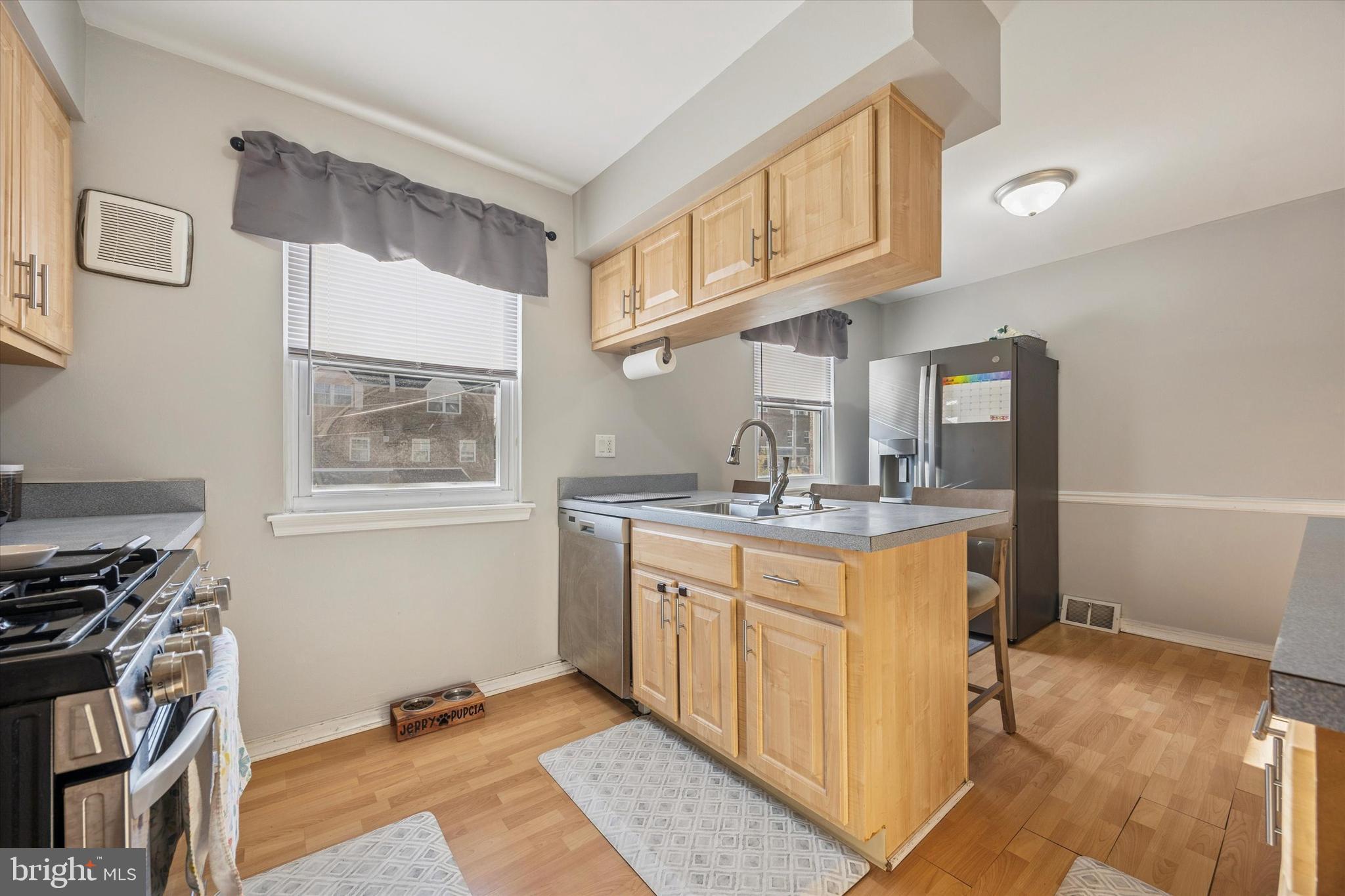 7011 Matthias Street Philadelphia, PA 19128 - Photo 8 of 28 a kitchen with stainless steel appliances granite countertop a stove and a sink