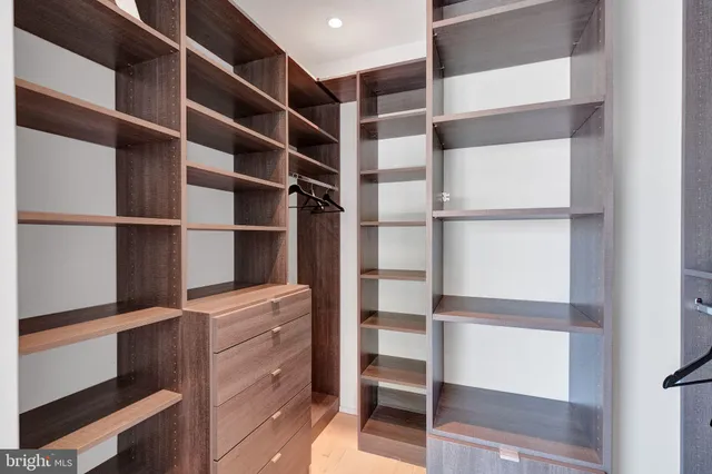 a bedroom with a bed and a tv on the dresser