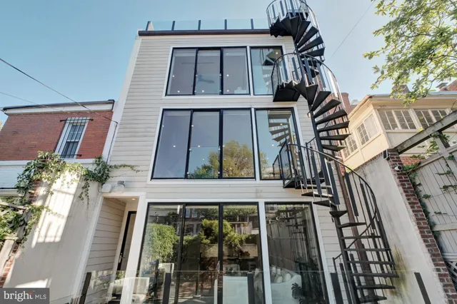 a front view of a multi story residential apartment building with yard