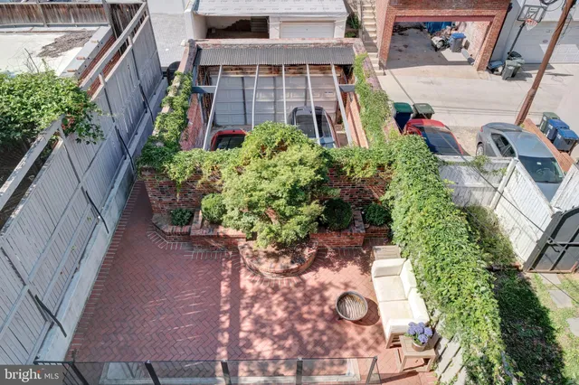a view of backyard with outdoor seating and plants