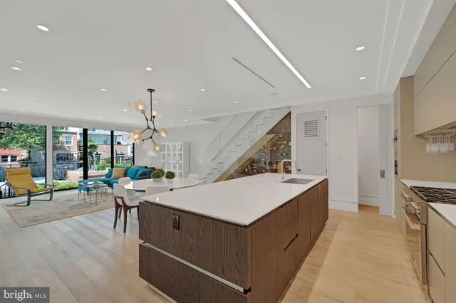 a kitchen with stainless steel appliances a sink stove and cabinets