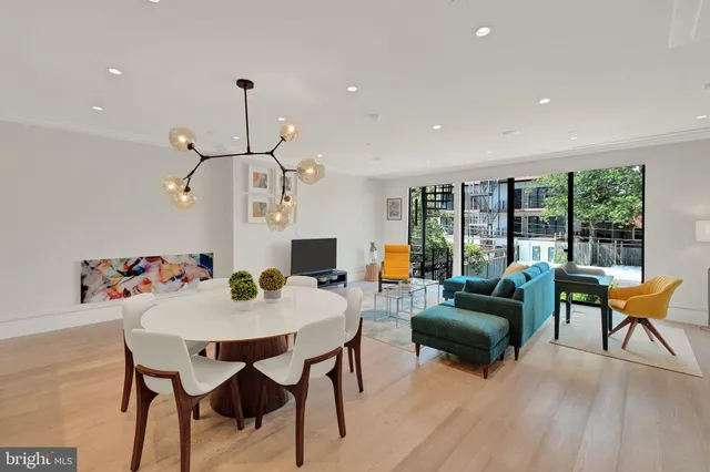 a living room with furniture and a floor to ceiling window