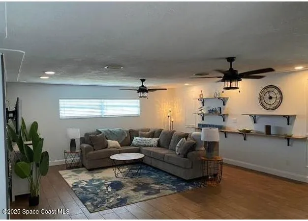 a living room with furniture a rug and a window