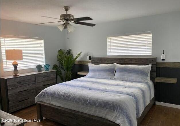 2130 South Patrick Drive Indian Harbour Beach, FL 32937 - Photo 5 of 14 a bedroom with a bed and a potted plant