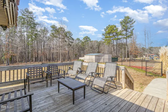 a view of balcony with wooden floor and outdoor seating
