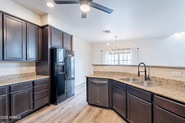 a kitchen with a sink and a stove top oven