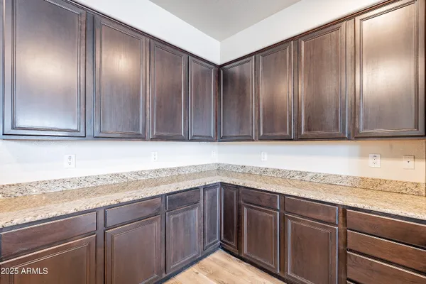 a kitchen with stainless steel appliances granite countertop a sink refrigerator and cabinets
