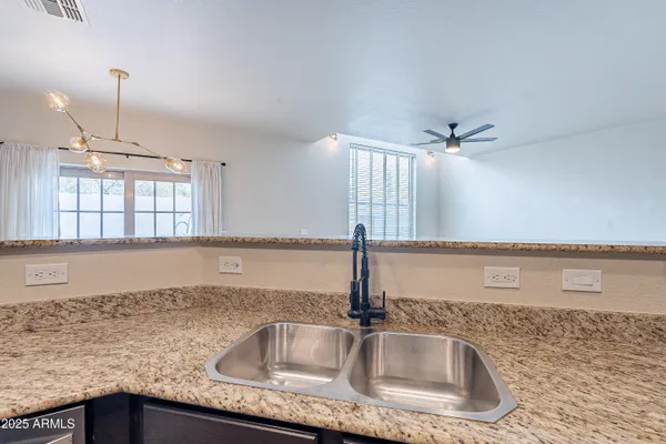 a kitchen with granite countertop a stove and a microwave