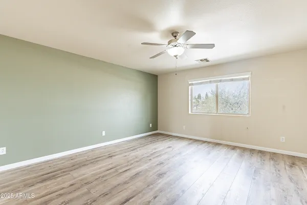 a view of a hallway with closet and a window
