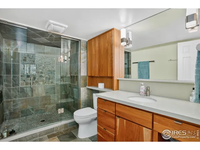 a living room with furniture a rug and a bookshelf