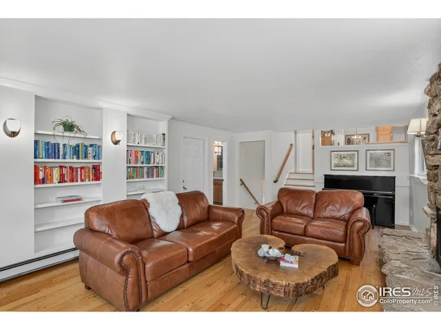 a living room with furniture a bookshelf and a fireplace