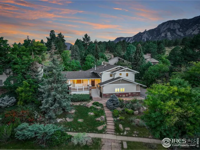 an aerial view of a house with a garden and lake view