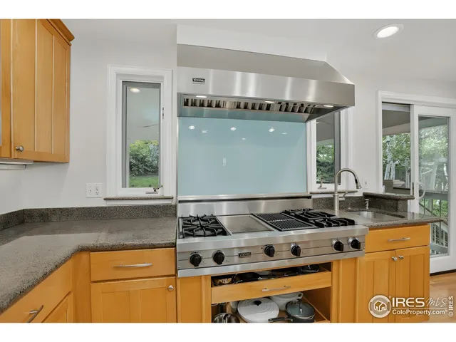 a kitchen with granite countertop a stove and a sink