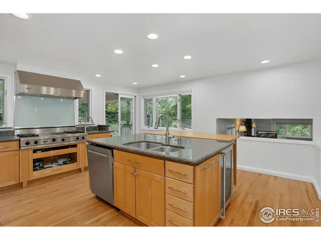 a kitchen with stainless steel appliances granite countertop a sink and a stove