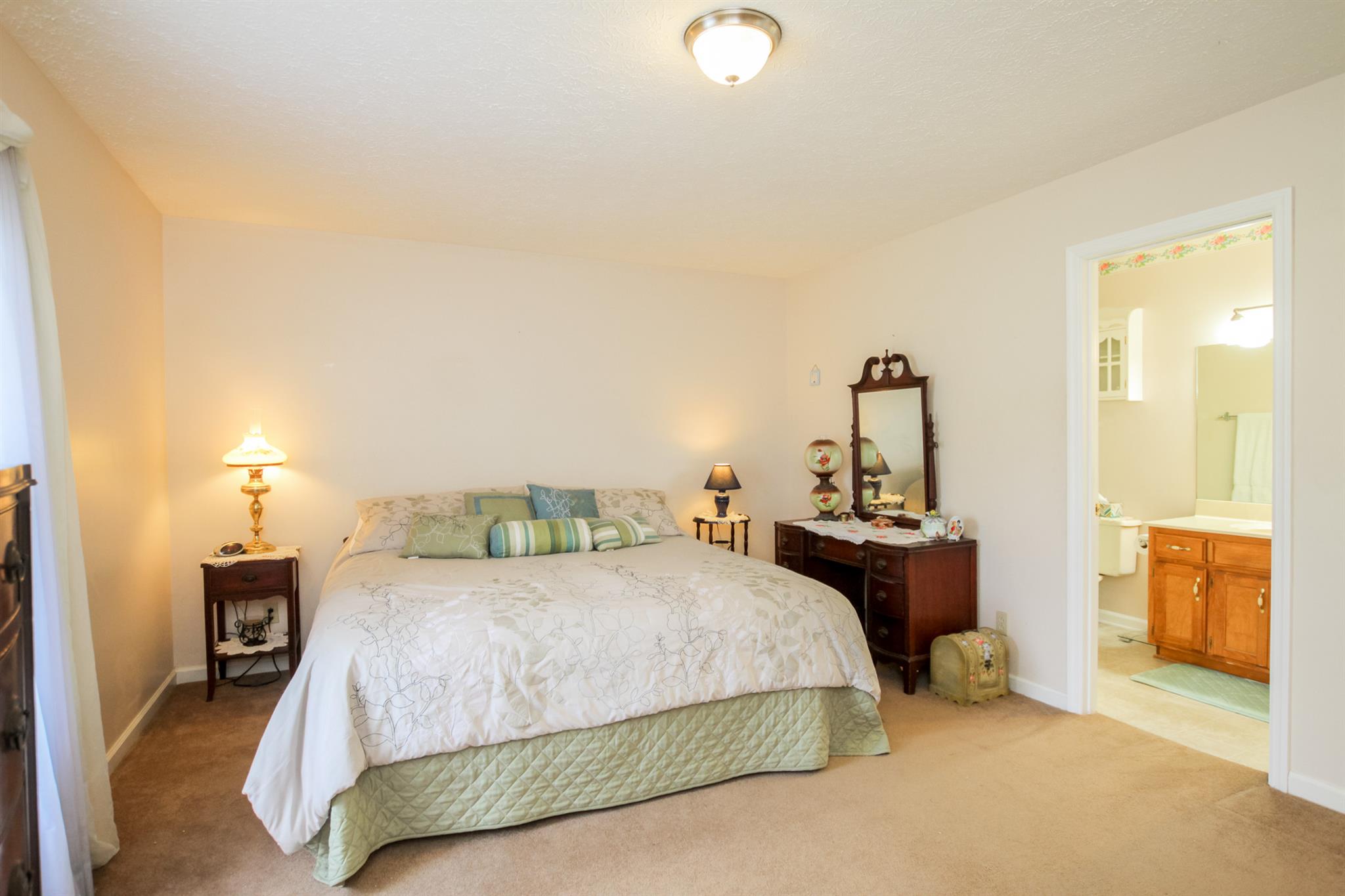 3902 Armstrong Road Springfield, TN 37172 - Photo 14 of 30 a bedroom with a bed and a table