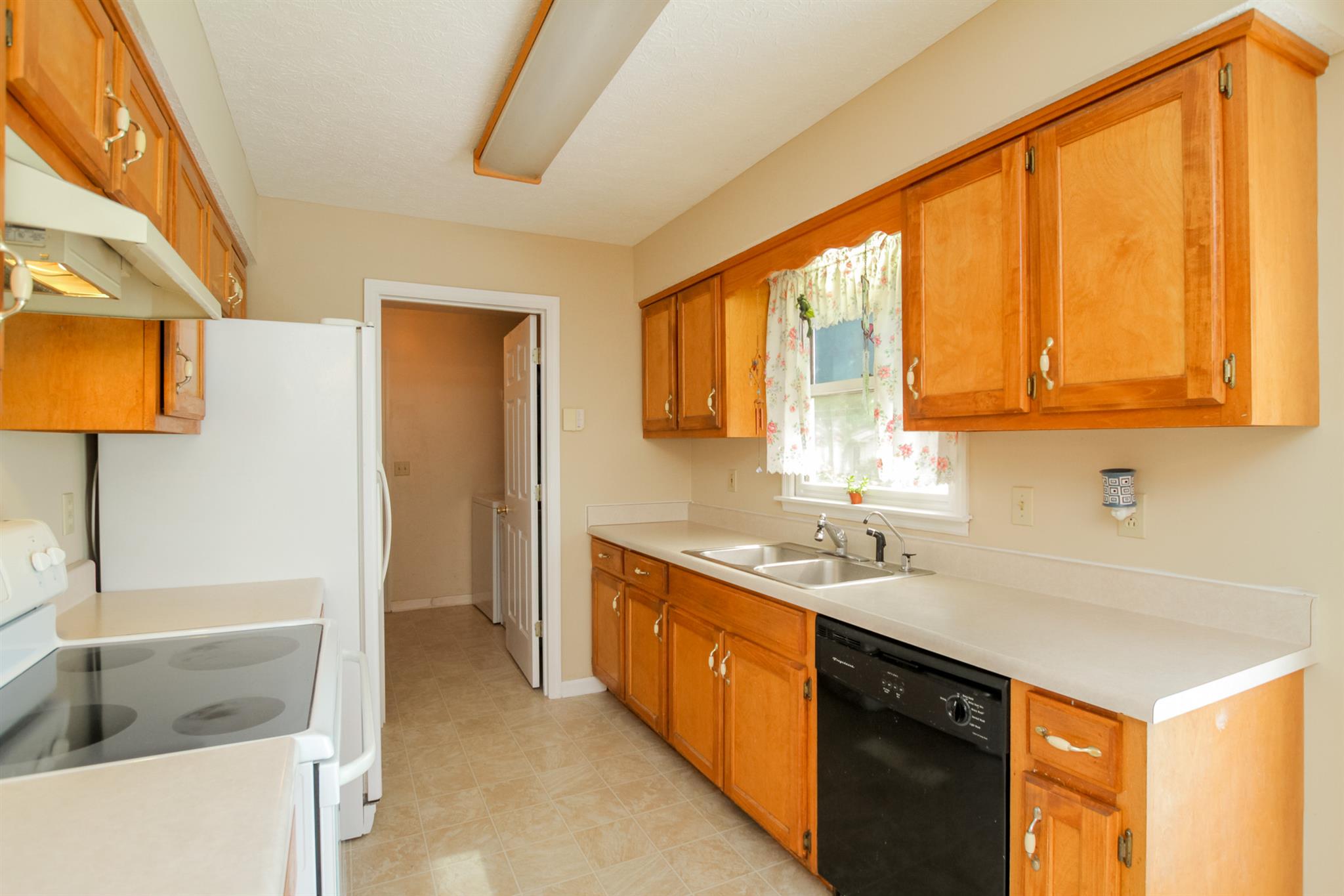 3902 Armstrong Road Springfield, TN 37172 - Photo 10 of 30 a kitchen with a sink a stove and a refrigerator