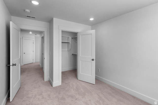 1237 West 500 South, Unit 230 Logan, UT 84321 - Photo 33 of 42 Bedroom featuring light-toned carpeting, white walls, recessed ceiling lighting, and a closet with built-in shelving